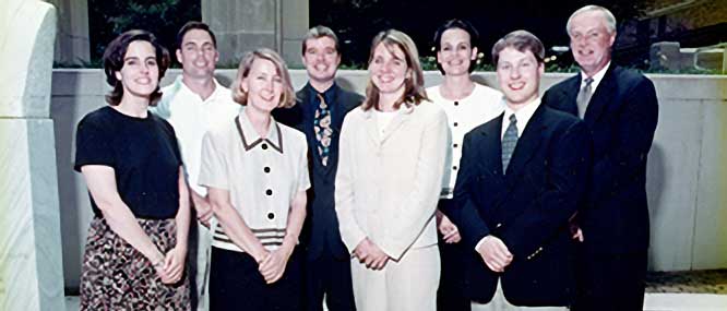 eight smiling residents from the class of 2000