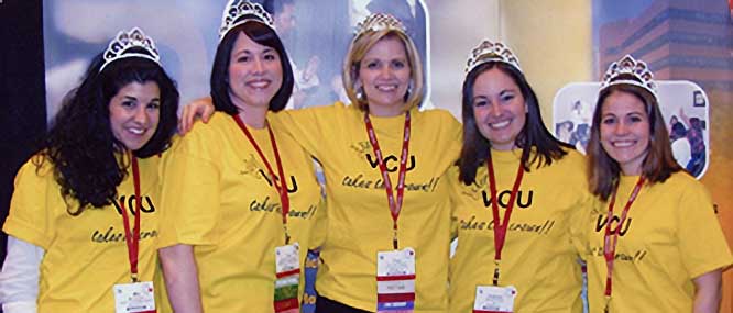 five smiling residents wearing matching shirts and tiaras from the class of 2010
