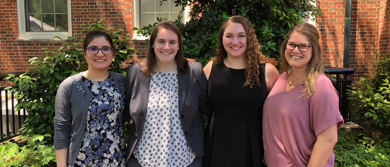 four smiling residents from the class of 2019