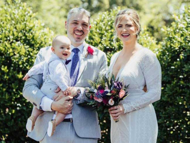 traci poole with her spouse and child on their wedding day